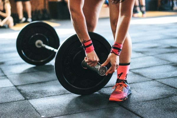 Person+Setting+Up+Weights+for+a+Strength+Training+Workout